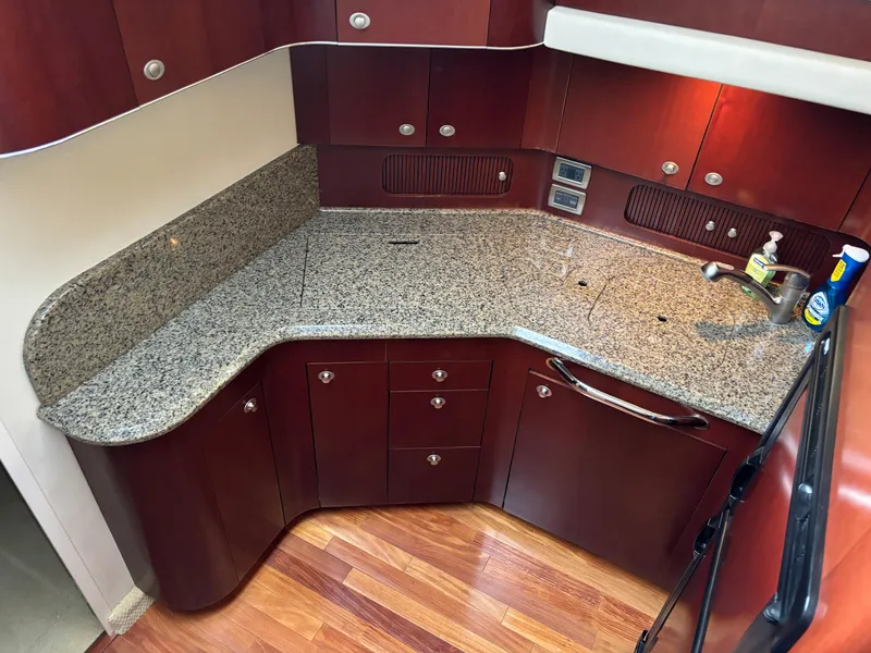 Slide: The Image of Luxurious kitchen in 2006 Sea Ray 40 Motor Yacht with granite countertops and wood cabinetry. - 19