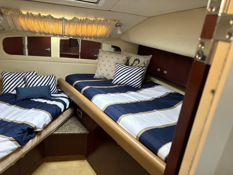 Slide: The Image of Interior of 2006 Sea Ray 40 Motor Yacht with twin beds and nautical decor. - 22