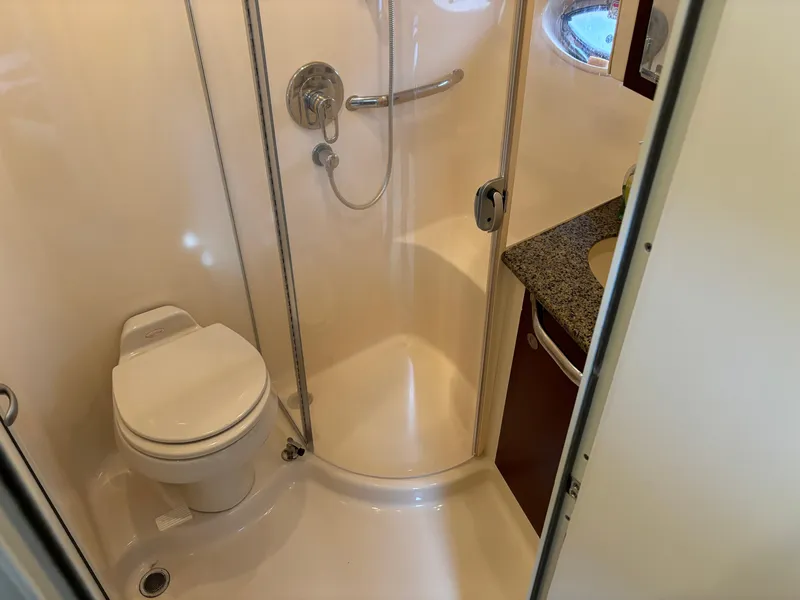 Slide: The Image of 2006 Sea Ray 40 Motor Yacht bathroom with shower, toilet, and granite countertop. - 24