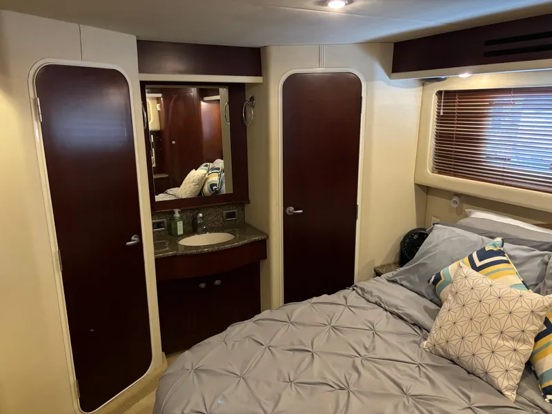 Slide: The Image of Luxurious 2006 Sea Ray 40 Motor Yacht bedroom with elegant bedding and wood accents. - 27