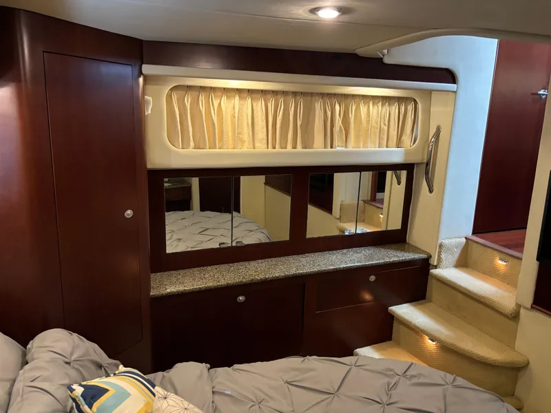 Slide: The Image of Interior of 2006 Sea Ray 40 Motor Yacht with elegant wood cabinetry and cozy bedding. - 28