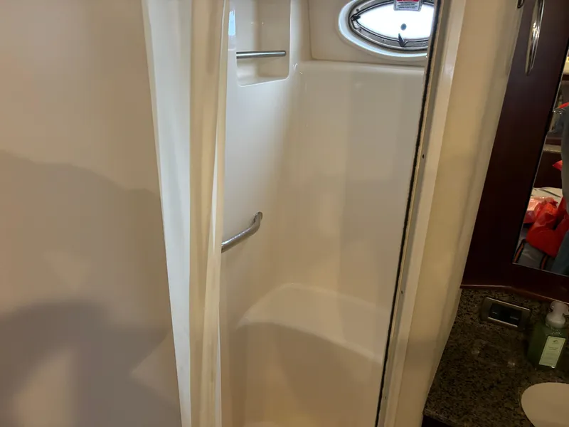 Slide: The Image of 2006 Sea Ray 40 Motor Yacht shower with porthole and granite countertop. - 31
