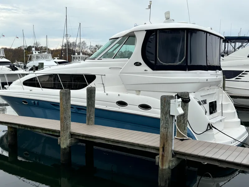 Slide: The Image of 2006 Sea Ray 40 Motor Yacht docked at marina, featuring sleek design and blue hull. - 4