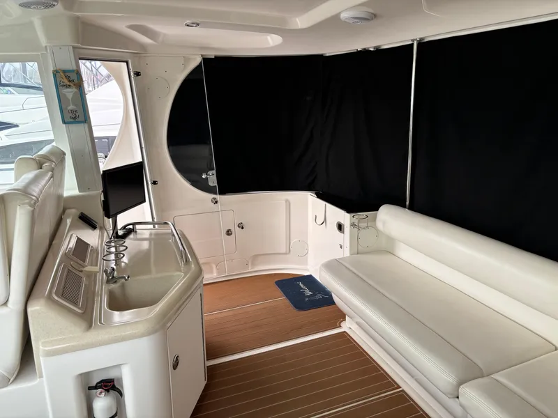 Slide: The Image of 2006 Sea Ray 40 Motor Yacht interior with white seating and kitchenette. - 5