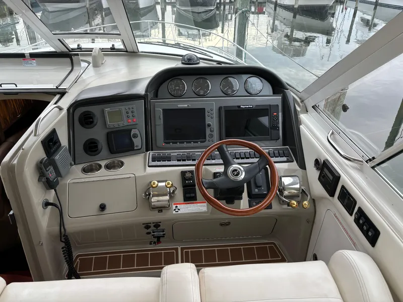 Slide: The Image of 2006 Sea Ray 40 Motor Yacht helm with navigation instruments and wooden steering wheel. - 9