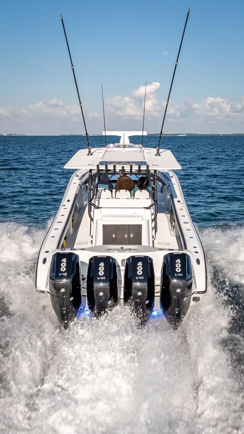 Slide: The Image of 2024 Yellowfin 42 boat with four engines cruising on open water. - 18