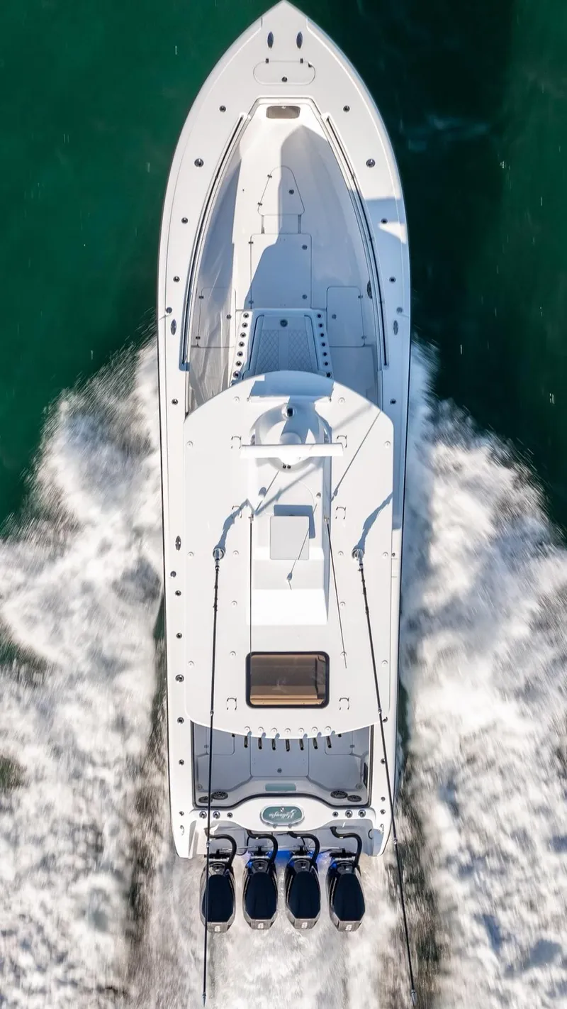 Slide: The Image of 2024 Yellowfin 42 boat cruising on open water, aerial view. - 22
