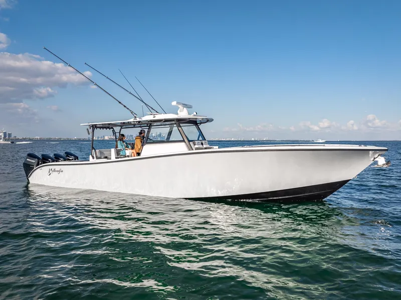 Slide: The Image of 2024 Yellowfin 42 boat cruising on open water under clear skies. - 24