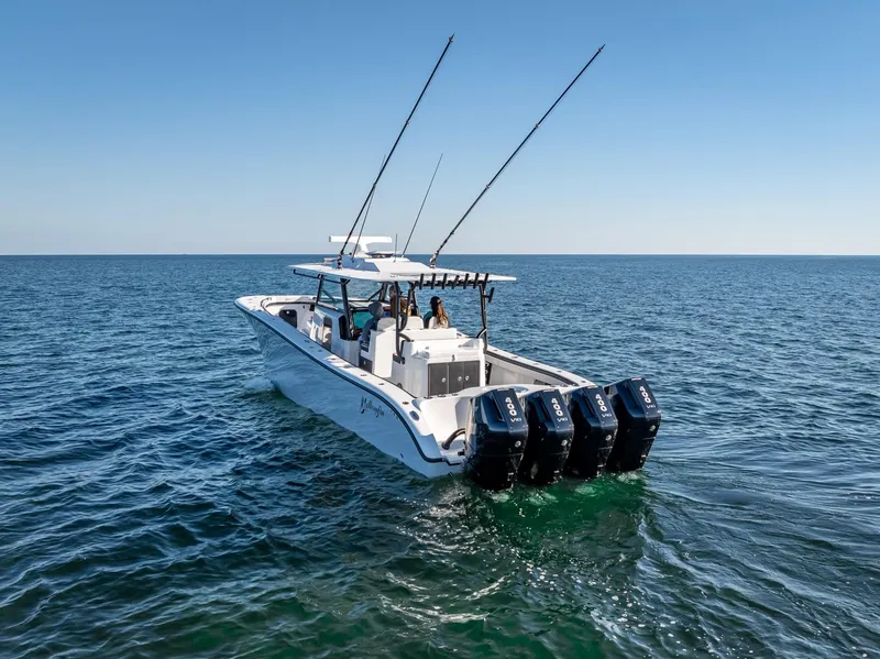 Slide: The Image of 2024 Yellowfin 42 boat with four engines cruising on open water. - 29