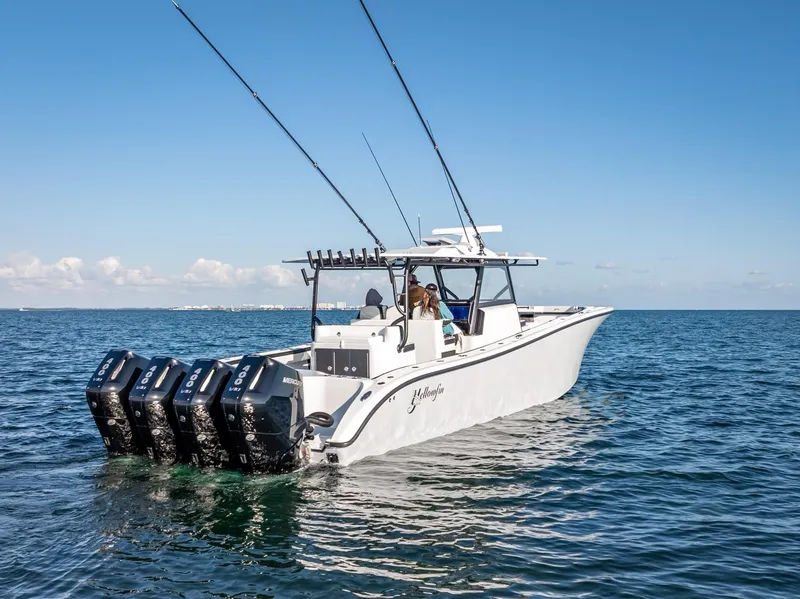 Slide: The Image of 2024 Yellowfin 42 boat with multiple outboard engines on open water. - 31