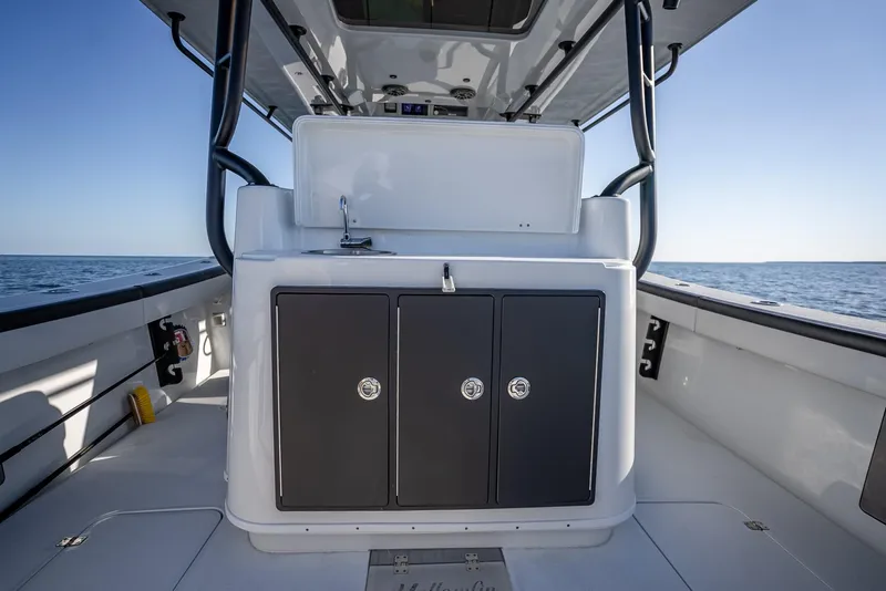 Slide: The Image of 2024 Yellowfin 42 boat interior with storage cabinets and ocean view. - 48