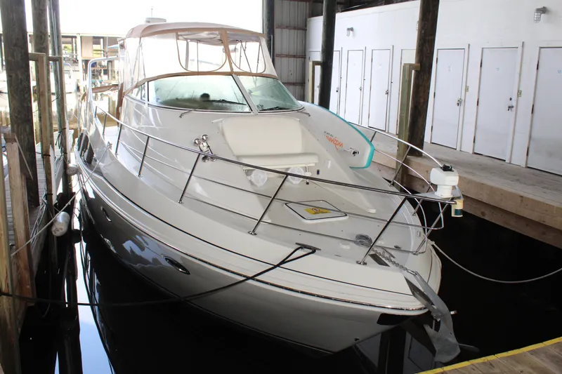 Slide: The Image of 2004 Carver 360 Mariner docked in a marina, showcasing sleek design and spacious deck. - 6