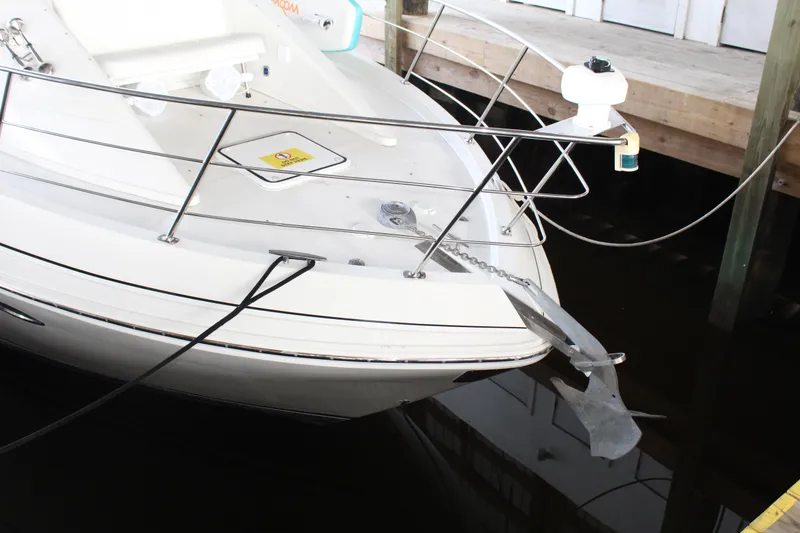 Slide: The Image of 2004 Carver 360 Mariner boat docked with anchor and railing visible. - 12