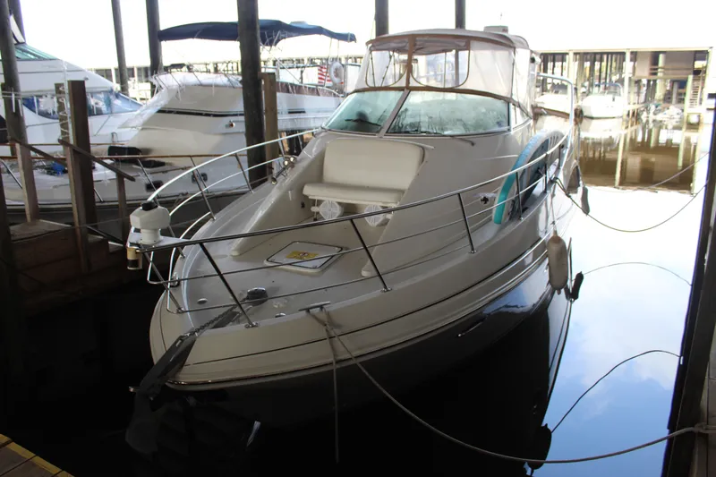 Slide: The Image of 2004 Carver 360 Mariner docked in a marina, surrounded by other boats. - 3