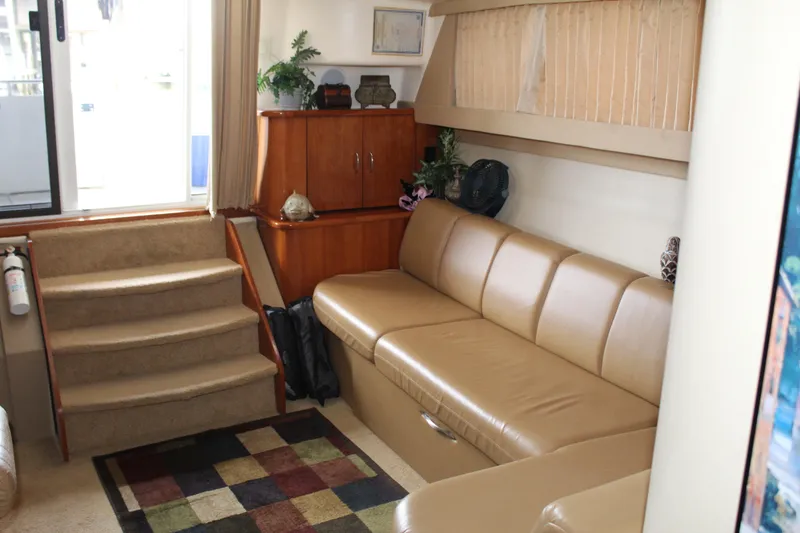 Slide: The Image of Interior of 2004 Carver 360 Mariner yacht with beige leather seating and wooden cabinetry. - 16