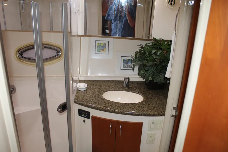 Slide: The Image of 2004 Carver 360 Mariner bathroom with granite countertop, sink, and shower. - 25