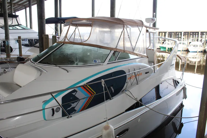 Slide: The Image of 2004 Carver 360 Mariner docked in a marina, featuring a sleek design and colorful graphics. - 5