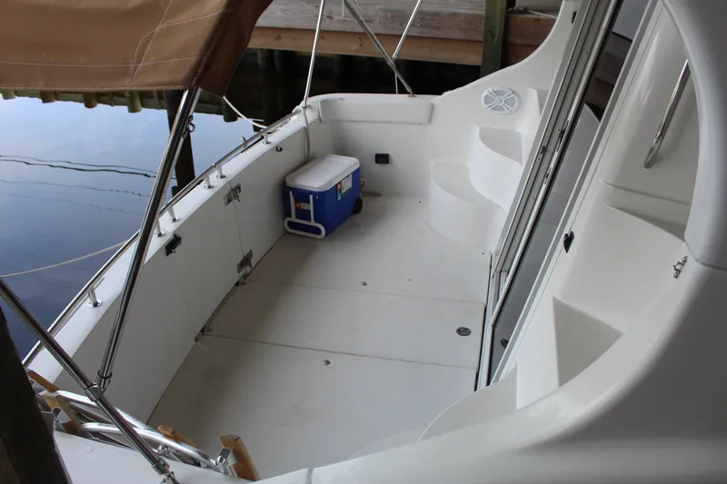 Slide: The Image of 2004 Carver 360 Mariner boat deck with seating and a cooler. - 14