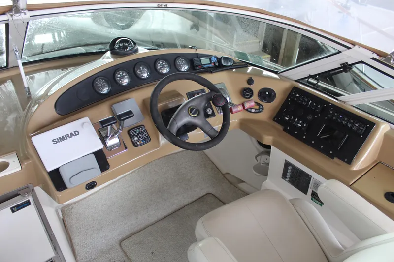 Slide: The Image of 2004 Carver 360 Mariner helm with steering wheel, gauges, and navigation equipment. - 28