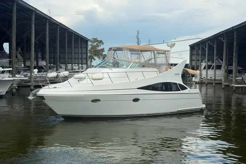 Slide: The Image of 2004 Carver 360 Mariner yacht docked in a marina, featuring sleek design and spacious cabin. - 1