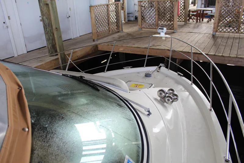 Slide: The Image of 2004 Carver 360 Mariner docked indoors, showcasing bow and deck features. - 13