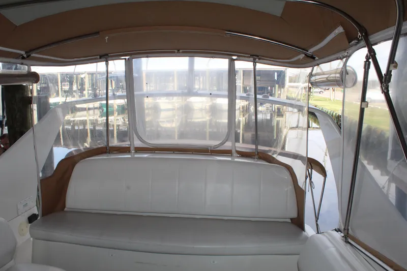Slide: The Image of 2004 Carver 360 Mariner boat interior with white seating and clear canopy. - 33
