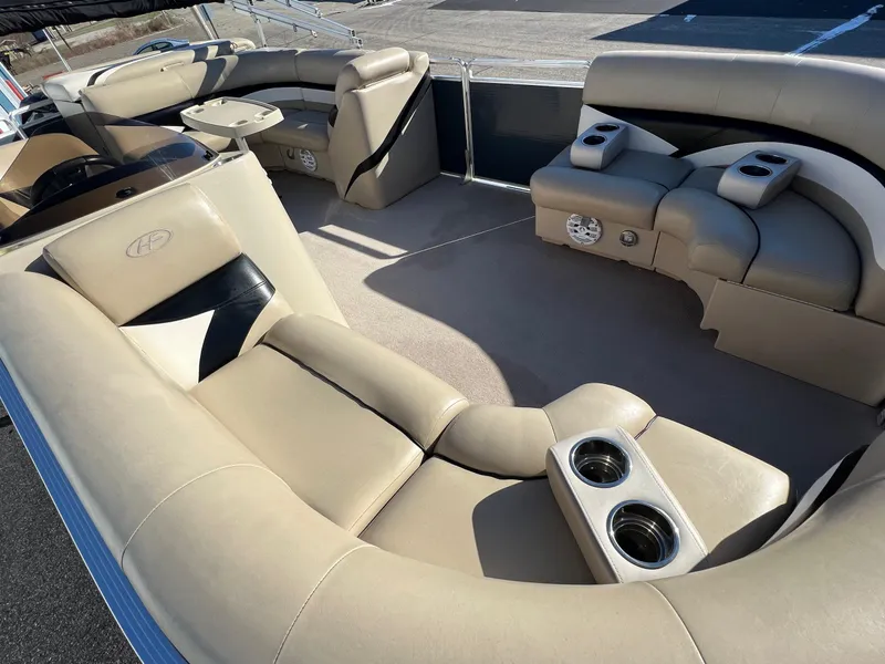 Slide: The Image of 2013 Harris FloteBote Cruiser interior with beige seating and cup holders. - 11