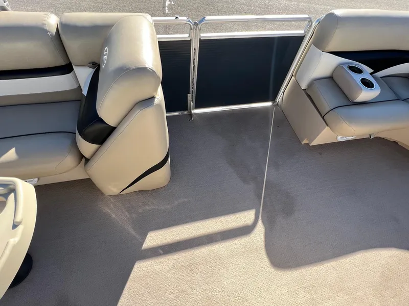 Slide: The Image of 2013 Harris FloteBote Cruiser interior with beige seating and cup holders. - 13
