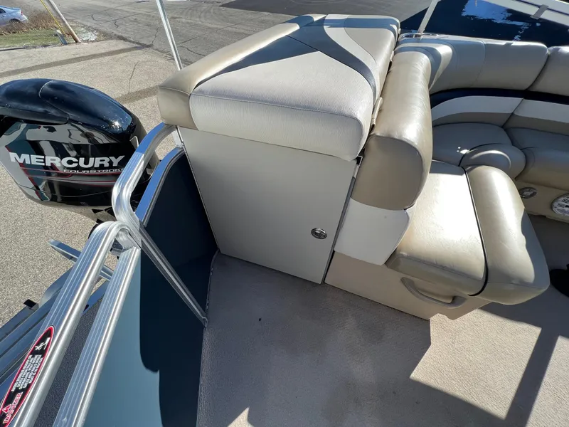 Slide: The Image of 2013 Harris FloteBote Cruiser with Mercury outboard motor and beige seating. - 17