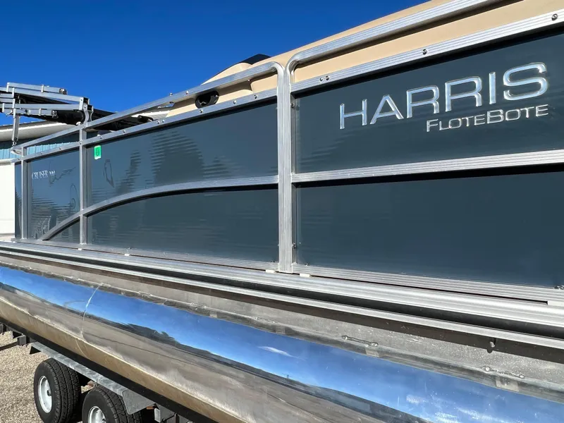 Slide: The Image of 2013 Harris FloteBote Cruiser pontoon boat on trailer, side view. - 2