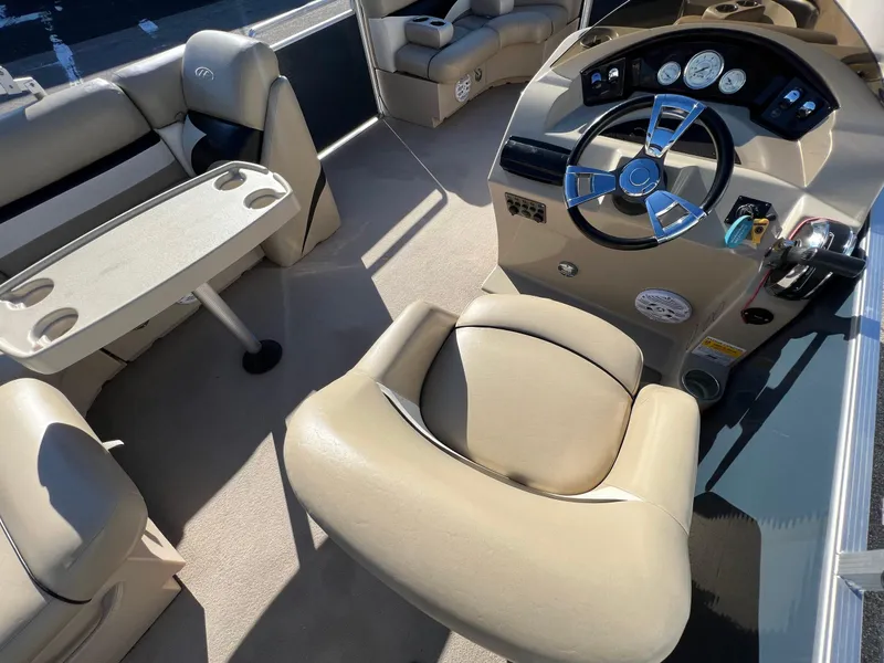 Slide: The Image of 2013 Harris FloteBote Cruiser interior with steering wheel and seating area. - 20