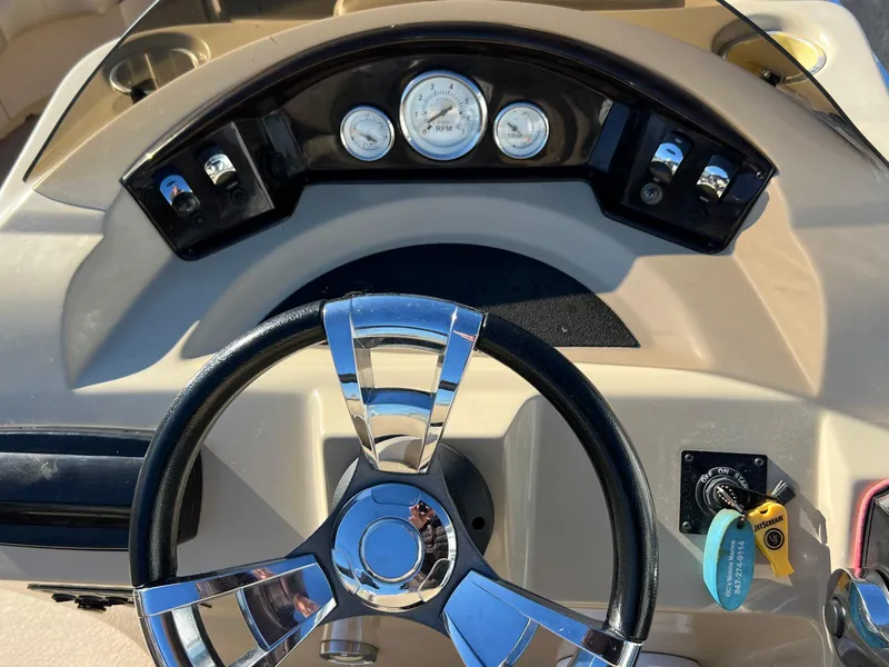 Slide: The Image of Steering wheel and dashboard of 2013 Harris FloteBote Cruiser boat. - 22