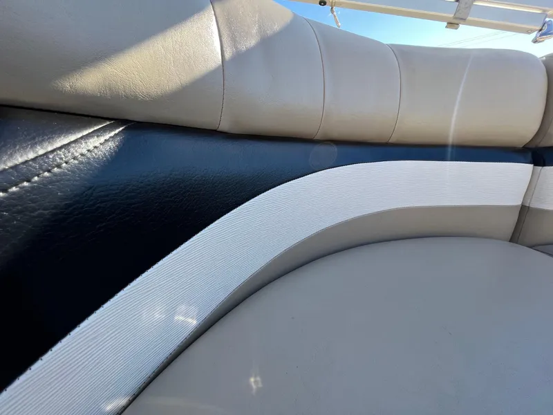 Slide: The Image of Close-up of 2013 Harris FloteBote Cruiser boat seating with beige and black upholstery. - 25