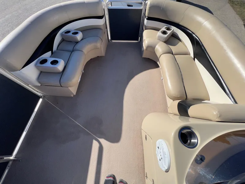 Slide: The Image of 2013 Harris FloteBote Cruiser interior with beige seating and cup holders. - 27