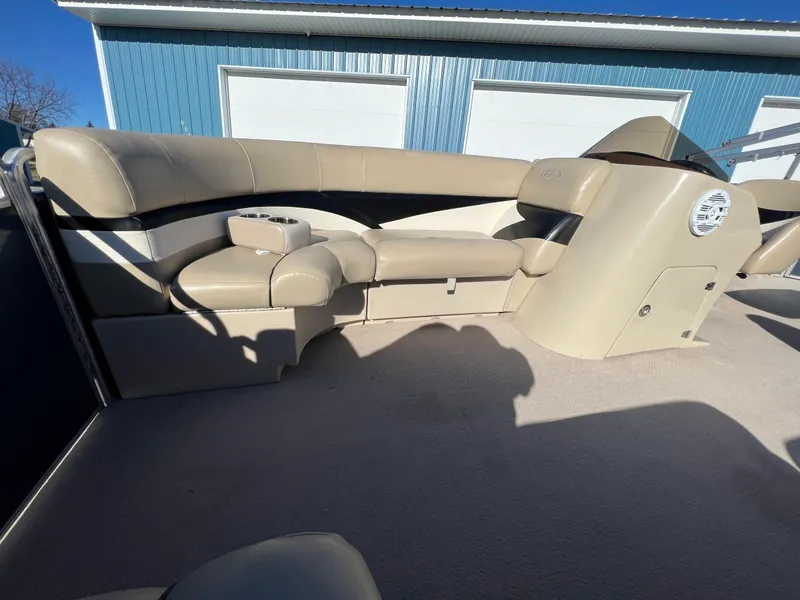 Slide: The Image of 2013 Harris FloteBote Cruiser interior with beige seating and cup holders. - 29