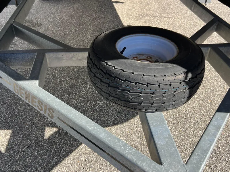 Slide: The Image of Spare tire on Genesis trailer frame for 2013 Harris FloteBote Cruiser. - 31