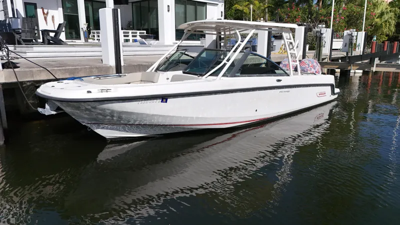 Slide: The Image of 2014 Boston Whaler 270 Vantage boat docked in a marina. - 5