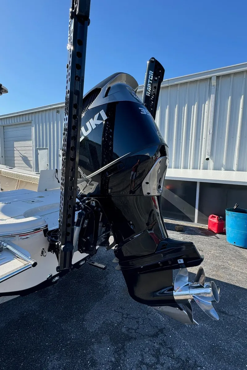 Slide: The Image of 2021 Sea Chaser 26LX boat with Suzuki outboard motor, docked outdoors. - 11