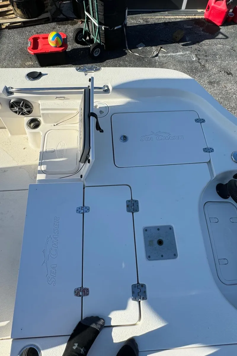 Slide: The Image of 2021 Sea Chaser 26LX boat deck with storage compartments and speaker. - 13