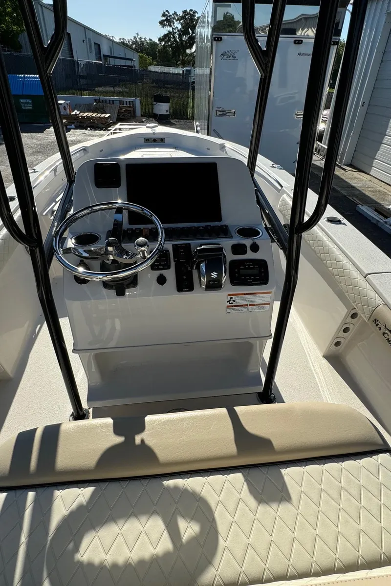 Slide: The Image of 2021 Sea Chaser 26LX boat console with steering wheel and control panel. - 14