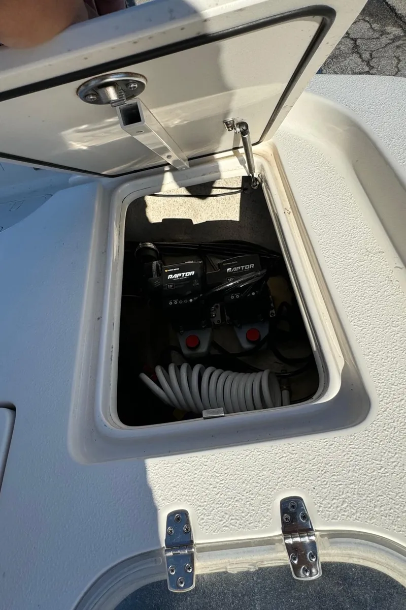Slide: The Image of Open hatch on 2021 Sea Chaser 26LX boat showing storage compartment and equipment. - 18