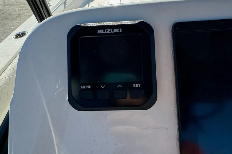 Slide: The Image of Control panel on a 2021 Sea Chaser 26LX boat featuring a Suzuki display. - 19