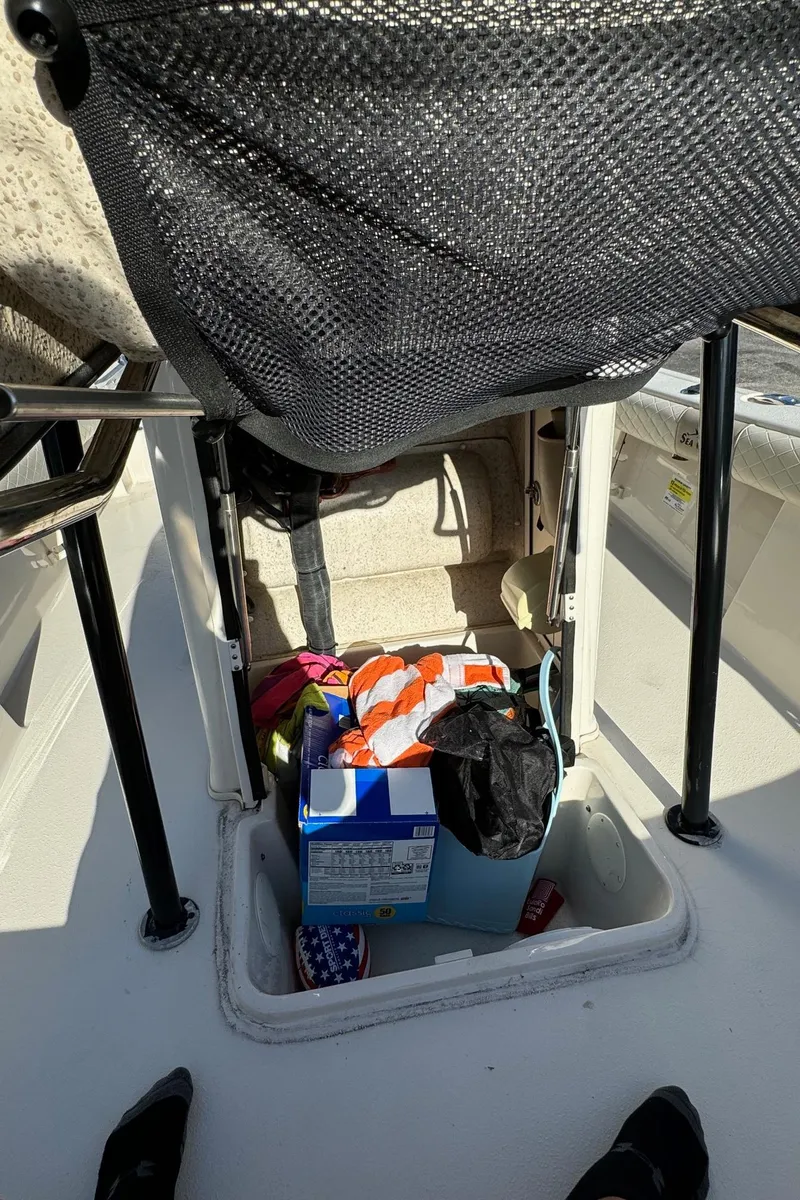 Slide: The Image of 2021 Sea Chaser 26LX boat storage compartment with various items inside. - 24