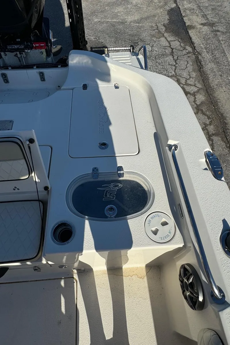 Slide: The Image of 2021 Sea Chaser 26LX boat deck with storage compartments and fishing features. - 25