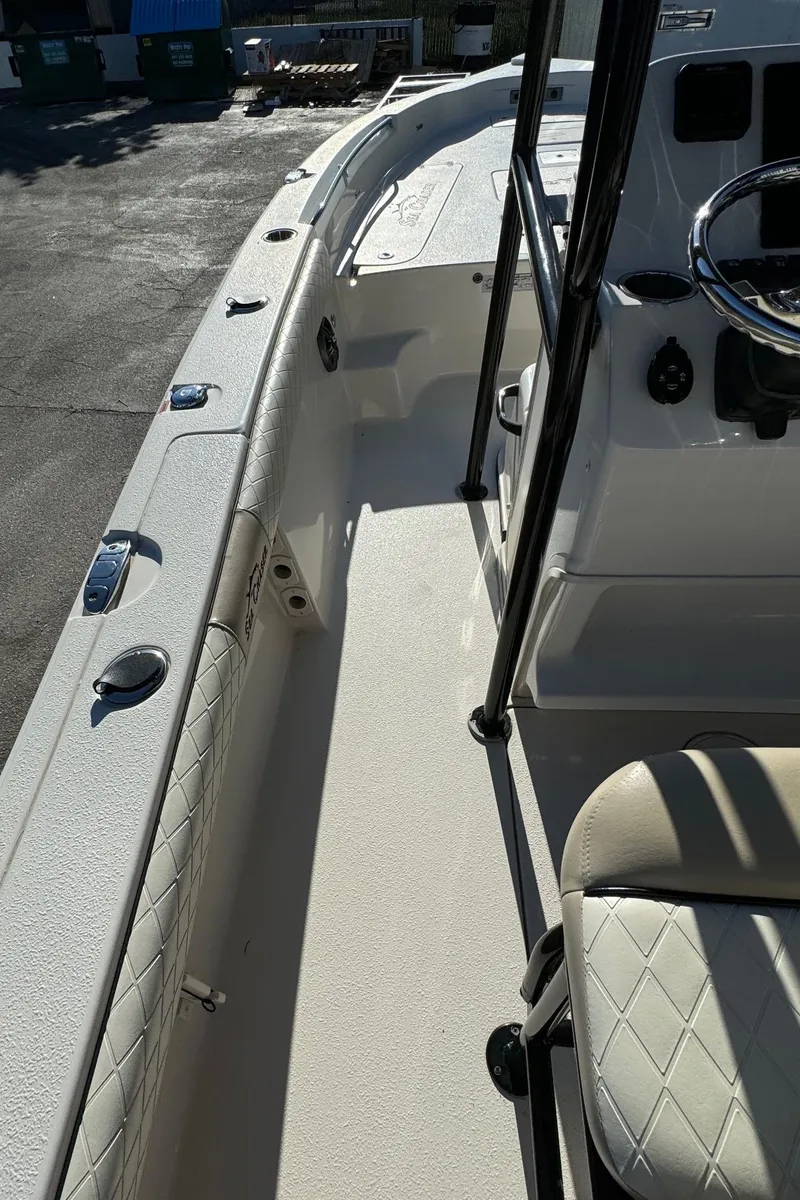 Slide: The Image of 2021 Sea Chaser 26LX boat interior with steering wheel and seating. - 26