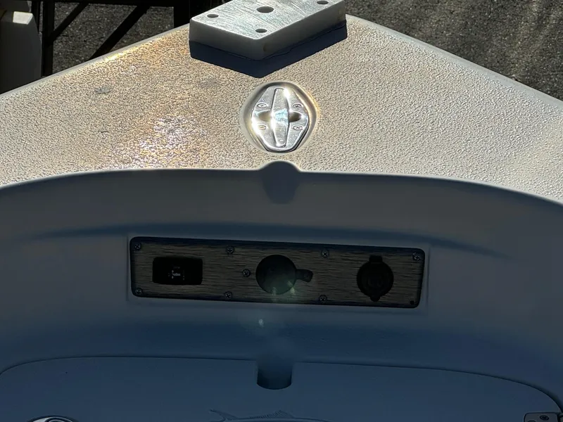 Slide: The Image of 2021 Sea Chaser 26LX boat dashboard with control panel and sunlight reflection. - 27