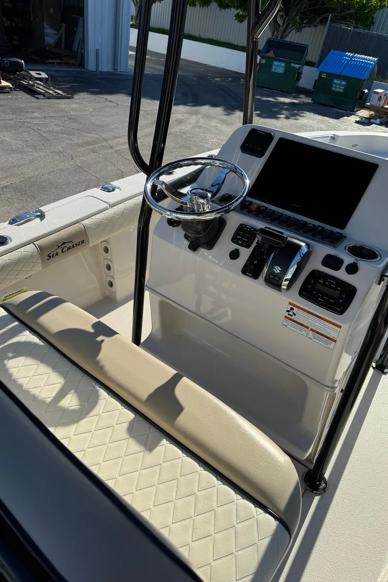 Slide: The Image of 2021 Sea Chaser 26LX boat console with steering wheel and controls. - 28