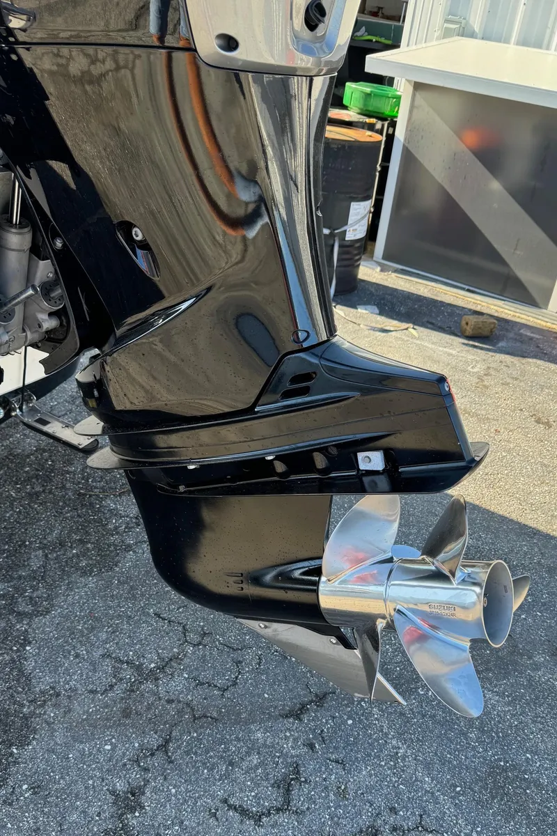 Slide: The Image of 2021 Sea Chaser 26LX boat motor with shiny propeller on pavement. - 29