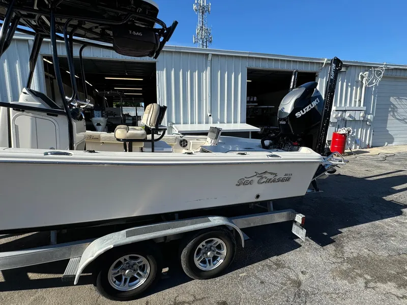 Slide: The Image of 2021 Sea Chaser 26LX boat on trailer, parked outside a garage. - 3