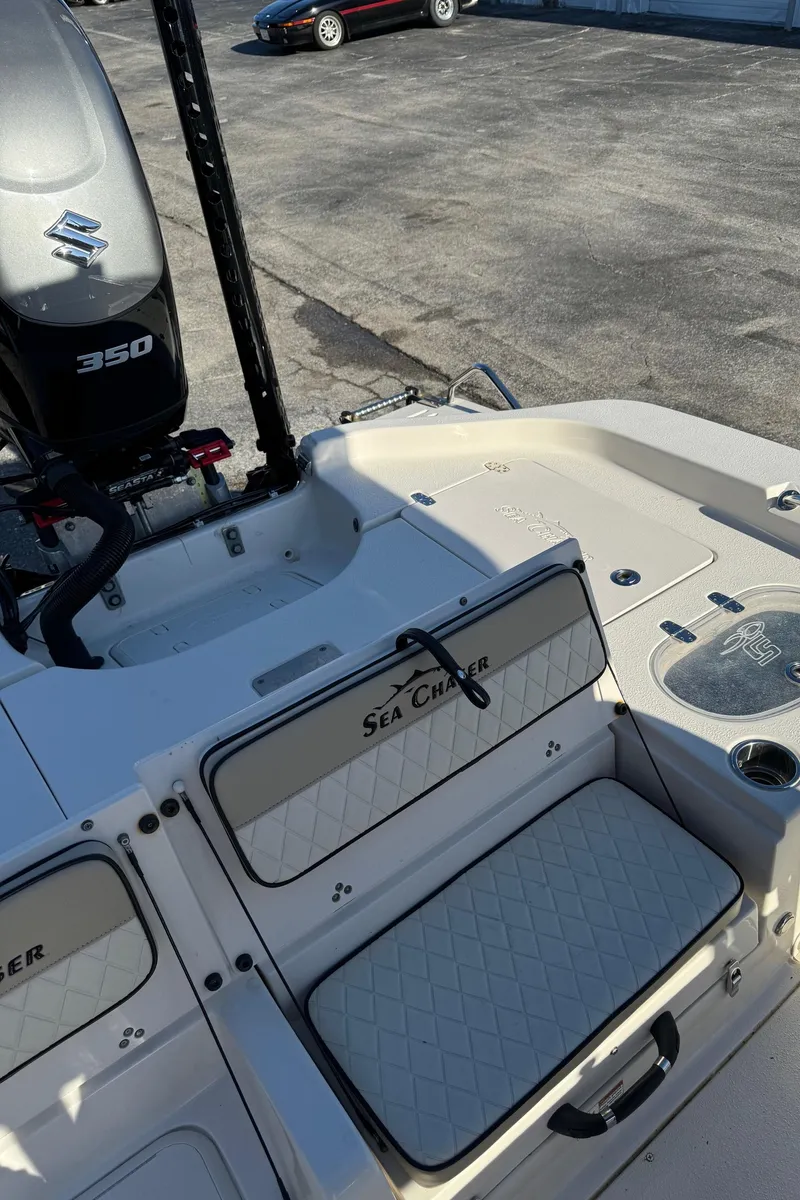 Slide: The Image of 2021 Sea Chaser 26LX boat interior with Suzuki 350 engine, docked on concrete. - 36